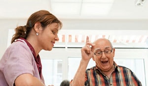 Enfermeira e doente num lar de idosos que favorece os biorritmos naturais com iluminação Philips